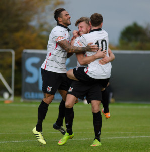Leon Scott and Nathan Cartman congratulate Lee Gaskell on his first goal