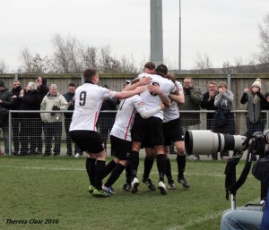 The players congratulate Kev Burgess after his winner