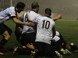 Skipper Kev Burgess is under there somewhere after scoring the first goal