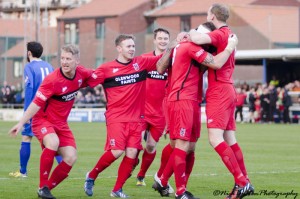 The players congratulate Kev after scoring against Whitby