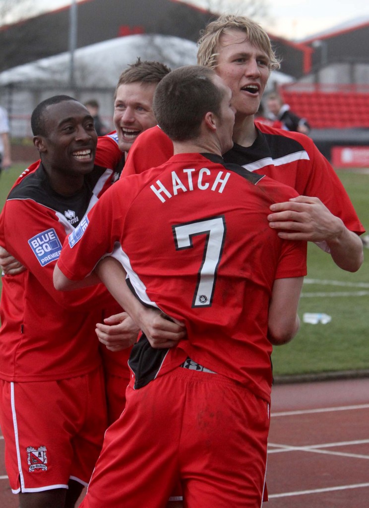 Darlington FC players celebrate following the game at Gateshead.