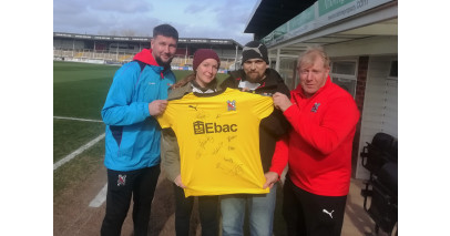 Staunch Darlington fans presented with a signed shirt