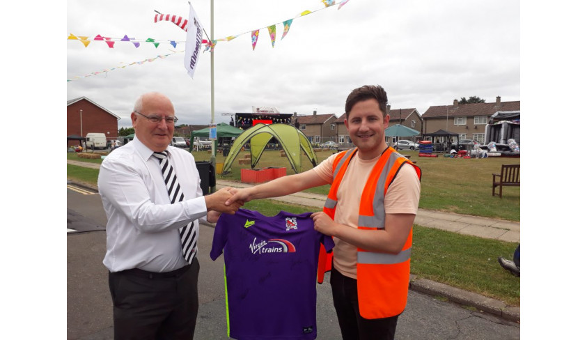 Quakers present a signed shirt to Firthmoor Community Centre