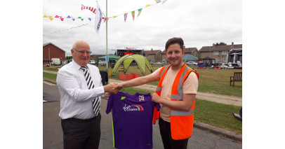 Quakers present a signed shirt to Firthmoor Community Centre